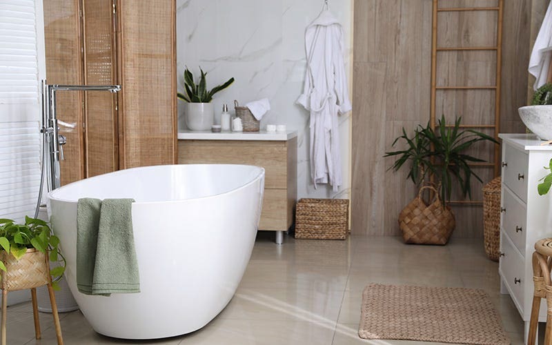 Une salle de bain avec une baignoire blanche et un rideau de douche en bois, créant une atmosphère chaleureuse et accueillante.