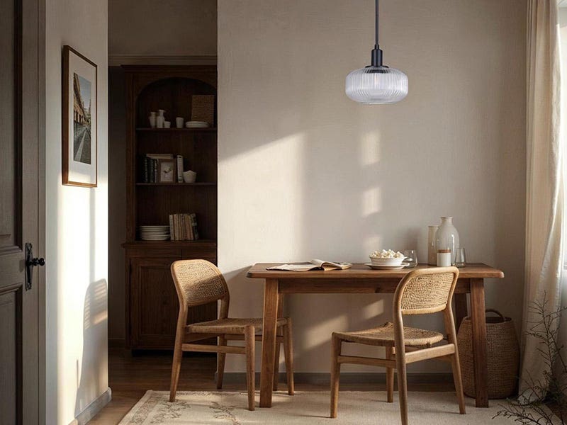 Warm dining space with a single glass pendant ceiling light