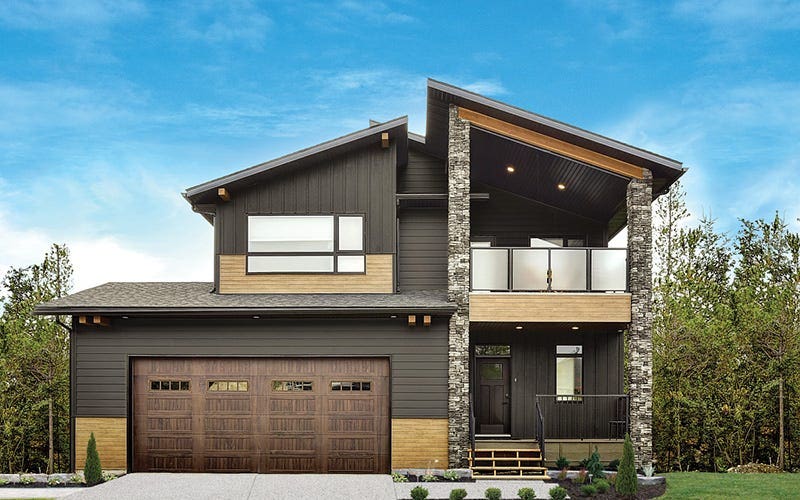 A two-story home featuring a garage and a welcoming porch.